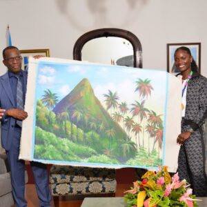 Prime Minister Philip J Pierre gifting painting to athlete Julian Alfred 